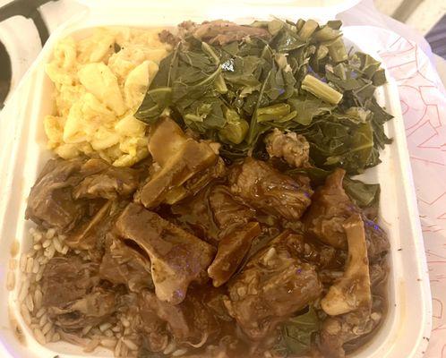 Oxtails dinner ( this is only a half an order )with Greens and macaroni and cheese