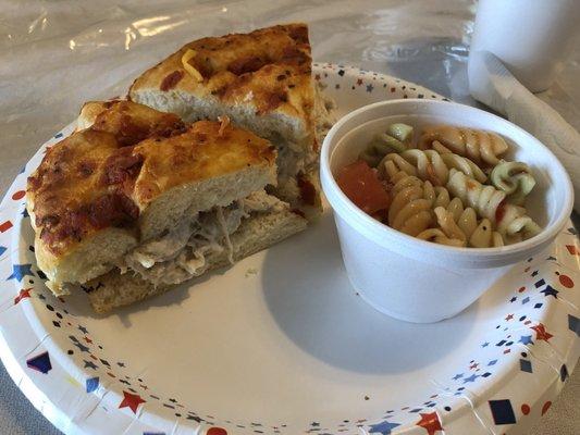 Carolina chicken salad sandwich with tomato basil focaccia bread and Italian pasta salad.