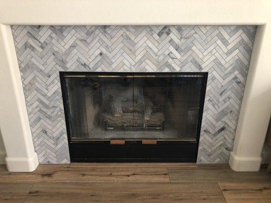 Newly re-tiles fireplace surround and newly installed LVP flooring