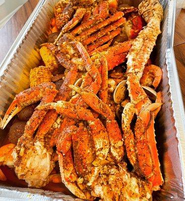 Snow crab, lobster, Dungeness crab, king crab, clams, shrimp, potatoes, corn, sausage