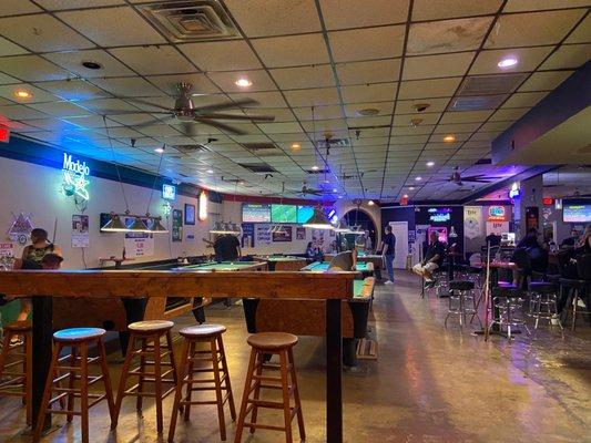 Shot of the standing bar/stools and counter by pool tables