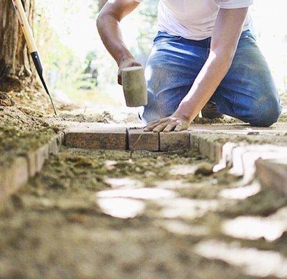 Reinstalling bricks from a section that we took out in order to do drainage!