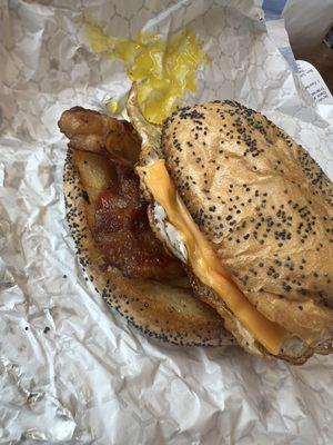 Bacon egg and cheese on a poppyseed roll