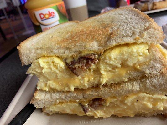 Scrambled eggs, bacon and grilled cheese sandwich