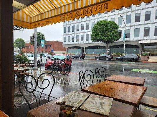 Sitting inside with a view of a not so busy street and rainy skies.