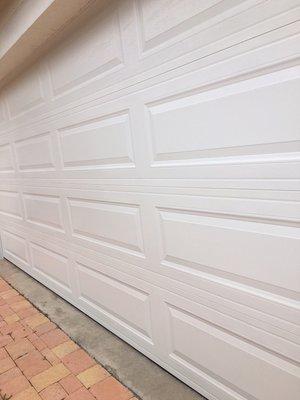 A garage door 16x7 long panel with insulation color white different sizes 9x7 8x7