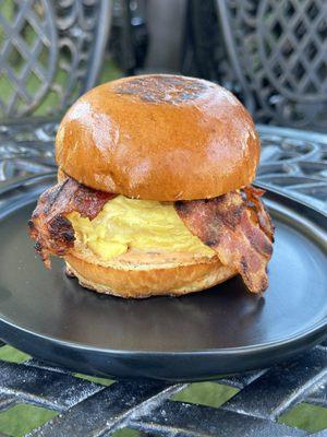 crispy bacon, white cheddar (vegan cheese option), & house remoulade with a fluffy egg on a brioche bun