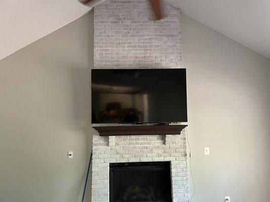 Mantel mount over brick fireplace. In up position