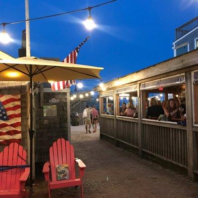 A side view of the porched dining area at Slip 14, located right at the harborside. Such a beautiful location in the heart of Nantucket.