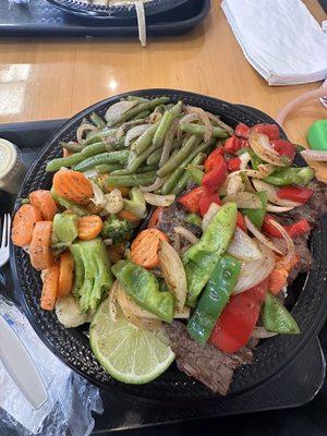 Carne Asada platter with rice and two sides included.