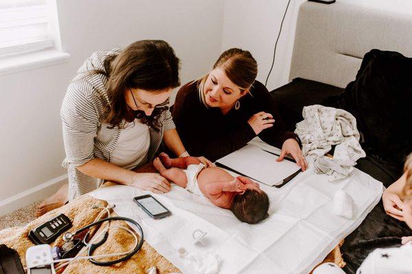 Newborn exam on the bed.