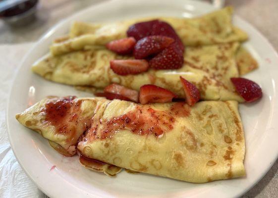 Cheese crepes with strawberries and strawberry sauce