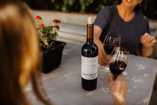 Guests enjoying a bottle of wine on the patio.