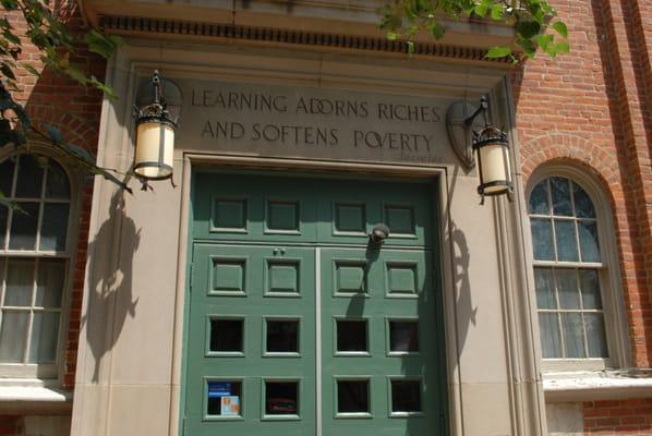 The old school building is well maintained as the door shows with original carvings. the lanterns are a nice touch too.