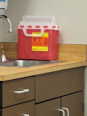 Open biohazard container sitting on the counter