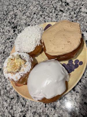 Coconut cream, key lime pie, raspberry filled and cinnamon maple frosted donuts