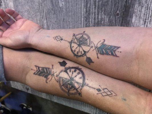 Matching compass and arrow tattoos