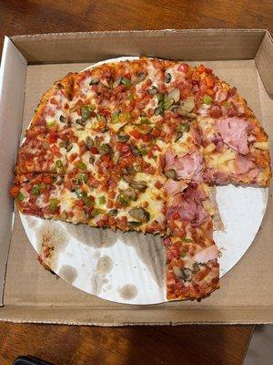 Somebody was too hungry to let me snap the pic first! This is  3/4 pepperoni, peppers and mushroom and 1/4 ham and pineapple.