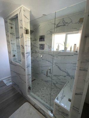 Shower with swinging glass door, glass side panel, and glass cut-out window panel