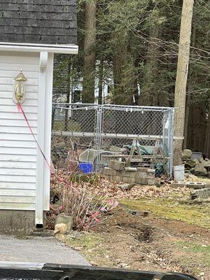 Caution tape attached to the garage with trench on the side