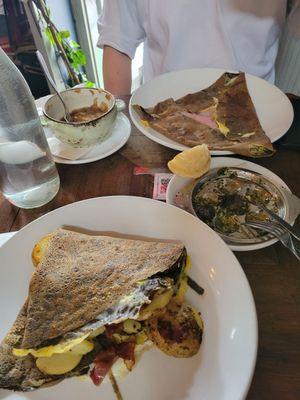 Bacon hash crepe in front; ham cheese egg crepe in back