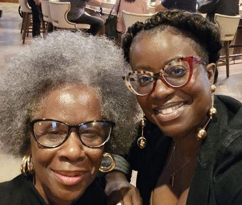 Mom with fresh afro, and me with crochet twists put into goddess braid.