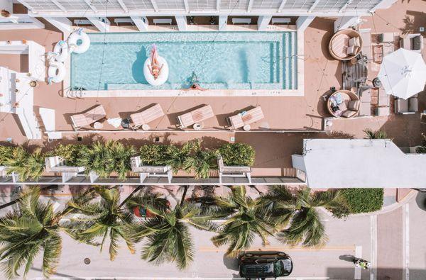 A sunlit rooftop gem, Miami Beach's hotel boasts panoramic ocean views, vibrant lounges, tropical cocktails, and chic, relaxing cabanas.