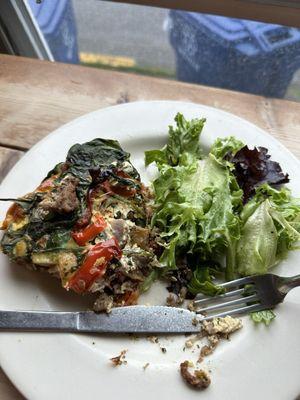 Breakfast dish with eggs, sausage, potatoes, spinach and red peppers