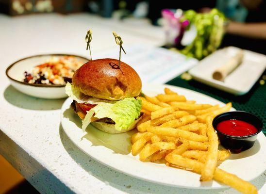 Impossible patty cheeseburger with fries and a side of beet salad