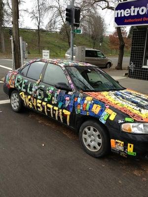 Car covered with phone cases outside Wireless World