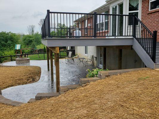 Stamped slate concrete with fire pit. Fiberon Beach house decking and Preferred  aluminum rails