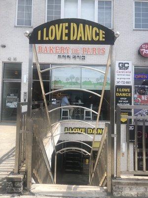 Entrance is downstairs next to bakery de paris