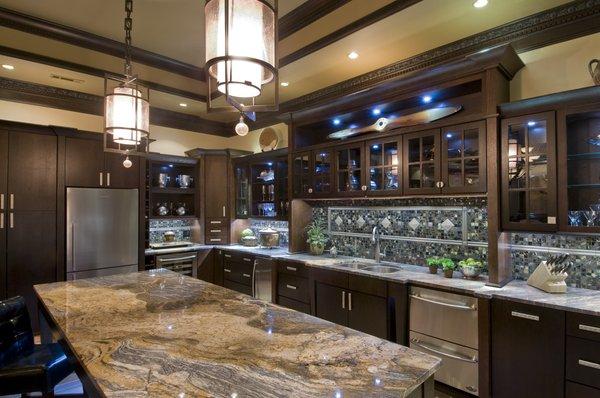 Kitchen remodel including custom back-splash feature, and island using Avenue Oak Mahogany cabinetry to add warmth and richness.