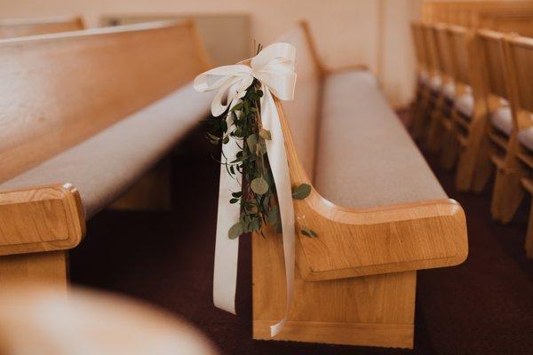 Beautiful simple greenery on pews