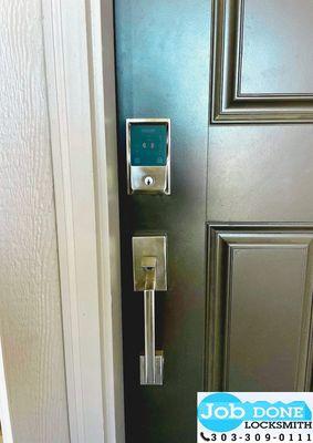 Our skilled technician installing a sleek keyless entry lock for enhanced home security.