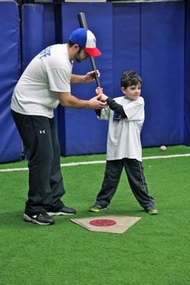 Coach Rob helping a mini slugger with his batting stance