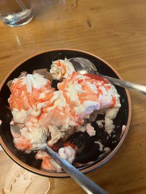 Messy dessert consisting of mochi and a strawberry cake.