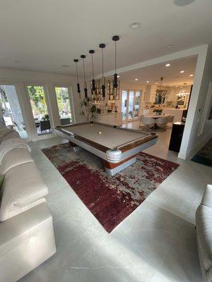 Modern rug under pool table helps break up the spaces and adds some beautiful texture to the space.