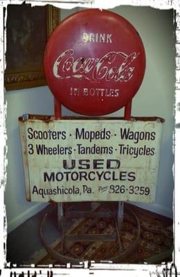 Antique coca cola advertising sign from motorcycle shop.