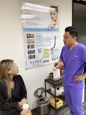 Doctor Kim does a brief consultation with a client about treatment recommendations or concerns.