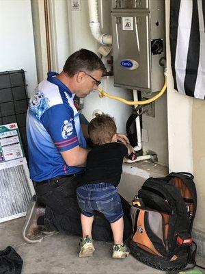 Performing maintenance on the furnace with a little bit of help from our customer