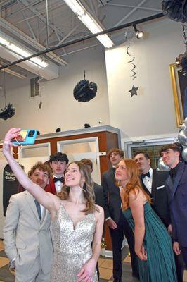 A group of young people wearing prom formalwear