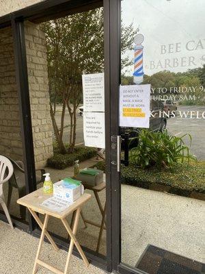 Masks and hand sanitizer provided in front of entry.