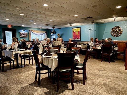 Dining room - taken 8/11/2021. Booths have a protective panel and tables are spaced out