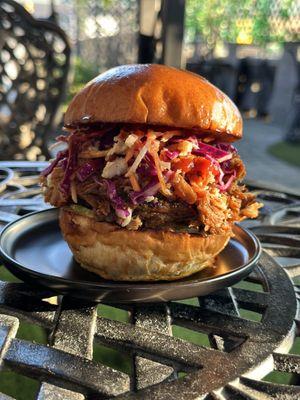 pulled pork smoked for 18hrs., house BBQ sauce, vinaigrette slaw, house pickles, remoulade, brioche bun