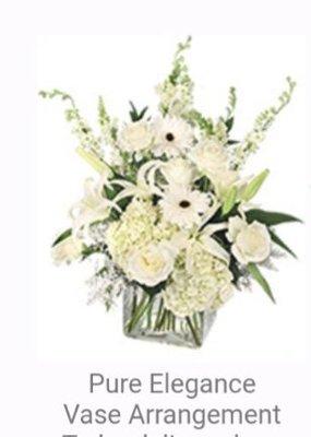 The stock image of the arrangement...notice how WHITE it  is, as well as the full-sized Roses, Gerber Daisies, Lillies, etc.