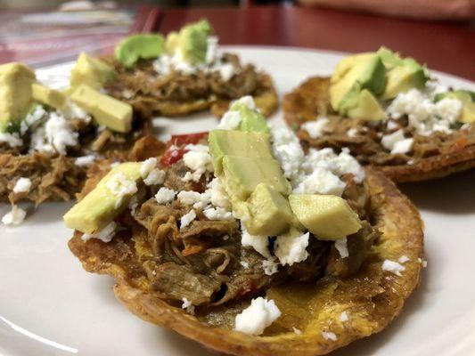 Shredded beef atop fried plantain with cheese & avocado