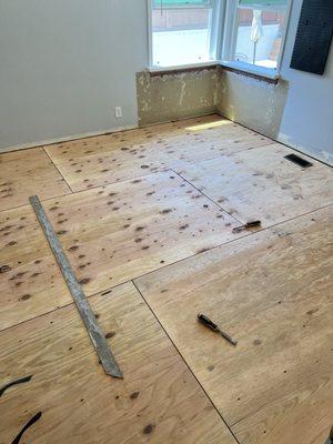 Plywood installed to match height of one room.