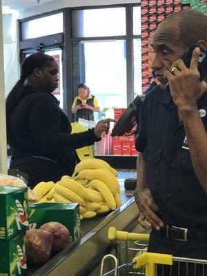 Associate at the front of the store on her phone