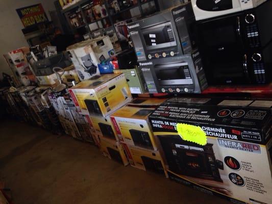 Lots of items to bid on. Countertop microwaves, vacuums, & quartz mantle fireplaces,office furniture, desks,air purifiers,& more